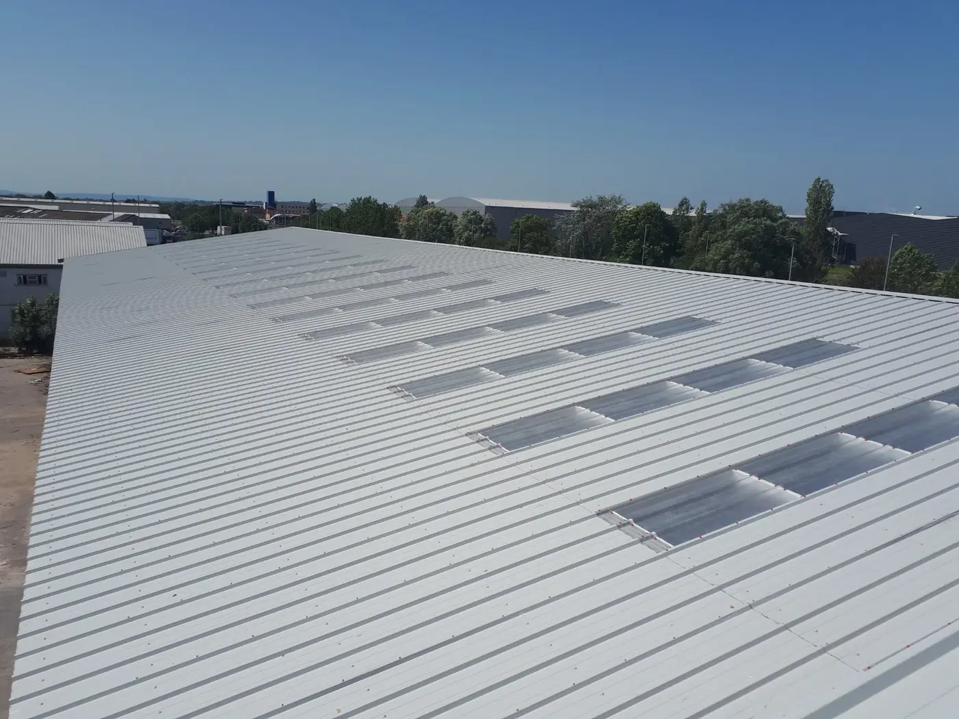 Roof sheeting and rooflight installation in progress