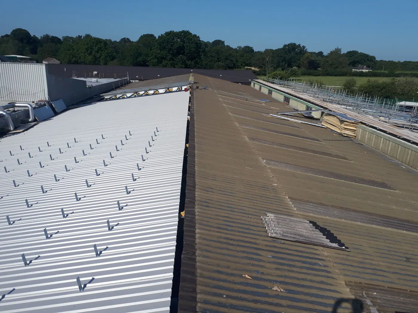New roof sheets alongside the original roof during refurbishment
