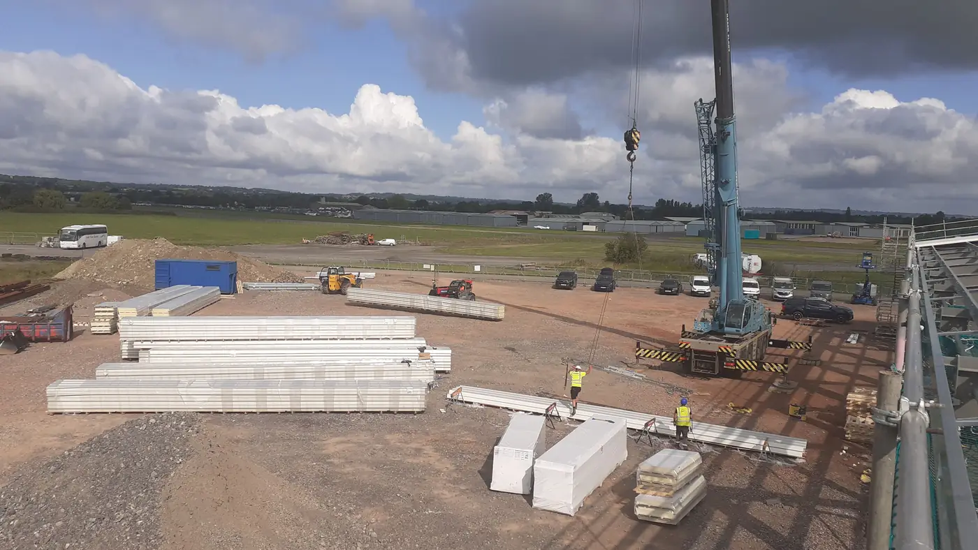 Crane lifting composite panels on site