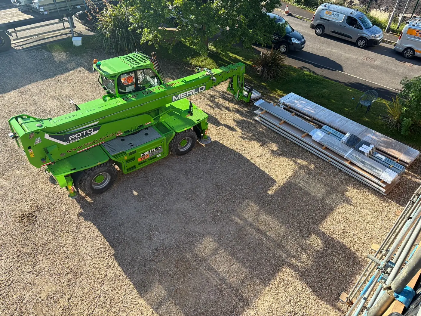 Telehandler and new roof sheets on site