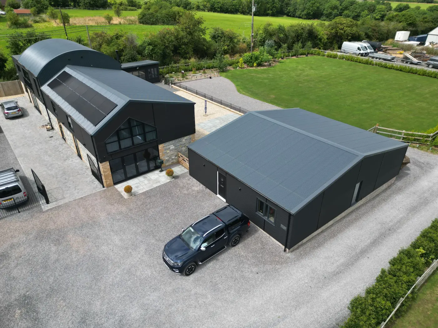 Converted barn home with a dark metal roof and cladding